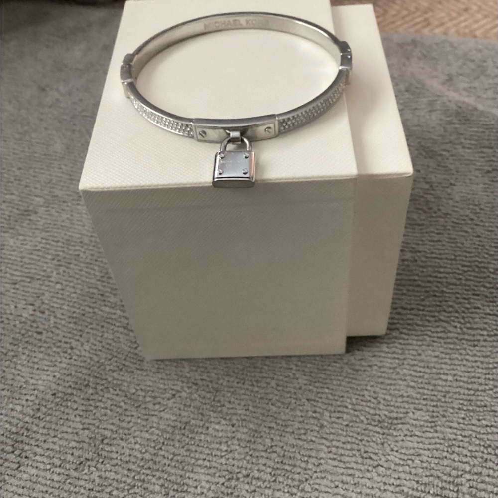 Michael Kors Silver Bangle Bracelet with Smooth Finish and Charm